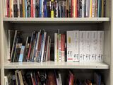a book shelf with many books on it in a library