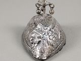 a close up of a silver object on a white surface