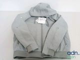 the jacket is grey and has a white tag on it