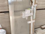 a large glass door in the middle of a pile of wood