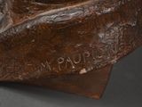 sculpture of a man ' s head on a wooden base with the word ' n papopopopopo ' written on it