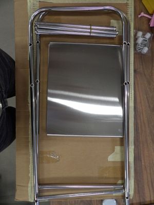 a metal chair that is sitting on a wooden table