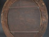 an image of a round wooden shelf with a label on it
