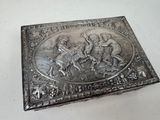 a silver box that has a picture of a man and a woman on it