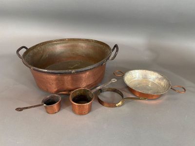 a lot of copper pots and pans sitting on a table
