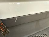 a measuring tape on the side of a white car