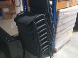 a lot of chairs that are stacked up in a warehouse
