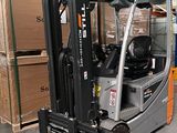 un chariot élévateur dans un entrepôt où se trouvent des palettes et des cartons