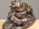 bronze statue of a bull and a dog on a rock