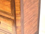 an image of a wooden chest of drawers on wheels