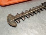 an old rusty pipe cutter on a table next to an orange tray