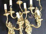 four light brass wall sconces with a dragon and flower design
