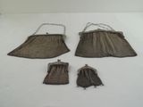 three brown purses and a chain on a white surface