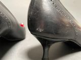 a close up of a pair of black shoes on a table