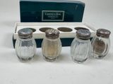 three salt and pepper shakers in a box with a box of salt and pepper shakers