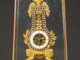 a glass case with a clock inside of it on a table