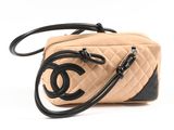 chanel beige and black quilted bag with black handles