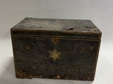 an old wooden box with a star design on it