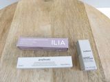 two boxes of lip butter sitting on top of a wooden table