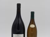 two bottles of wine that are sitting next to each other