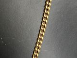 a close up of a gold chain necklace on a mannequin mannequin mannequin mannequin mannequin mannequin mannequin mann
