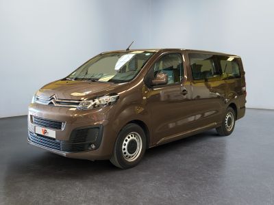 the brown van is parked in a large room with a black floor