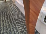 a wooden table with a clock on it in a room