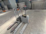 a forklift that is sitting in a warehouse