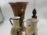 three vases and a lamp on a white table