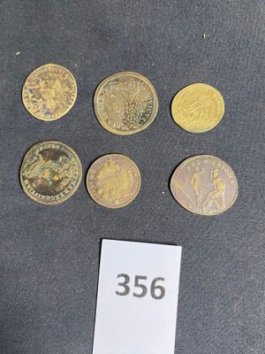 five different types of coins on a table with a price tag