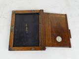 a small wooden box with a clock inside of it
