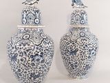 une paire de vases bleus et blancs sur lesquels sont posés des oiseaux