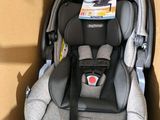 a baby car seat in a box with a tag on it