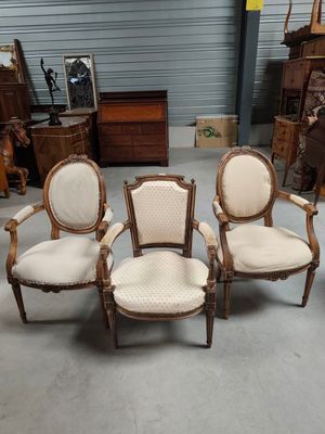 four chairs in a room with a lot of furniture in the background