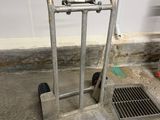 a hand truck with two baseball bats on top of it
