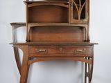 an old wooden desk with a glass door on top of it
