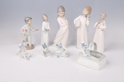 five figurines of people with a baby in a crib