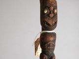a wooden pole with a carved face on it