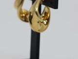 a pair of gold plated earrings on a black stand