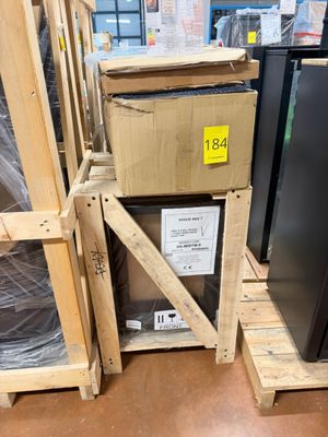 a black refrigerator sitting on a pallet in a store