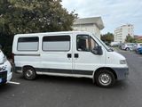 a white van parked in a parking lot next to a white car