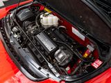 the engine compartment of a red sports car with its hood open