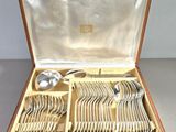a wooden box with silverware in it on a table