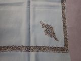 a picture of a blue scarf with a bird embroidered on it