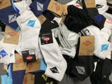 many pairs of socks that are on the floor