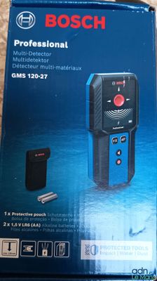 the box of the bosch professional laser measurer is open on the floor