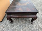 a coffee table that has a glass top on it