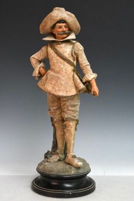 figurine représentant un homme avec un chapeau et une canne