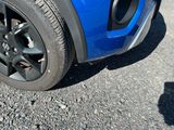 a close up of a tire on a blue car