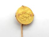 an image of a gold coin on a stick on a white surface